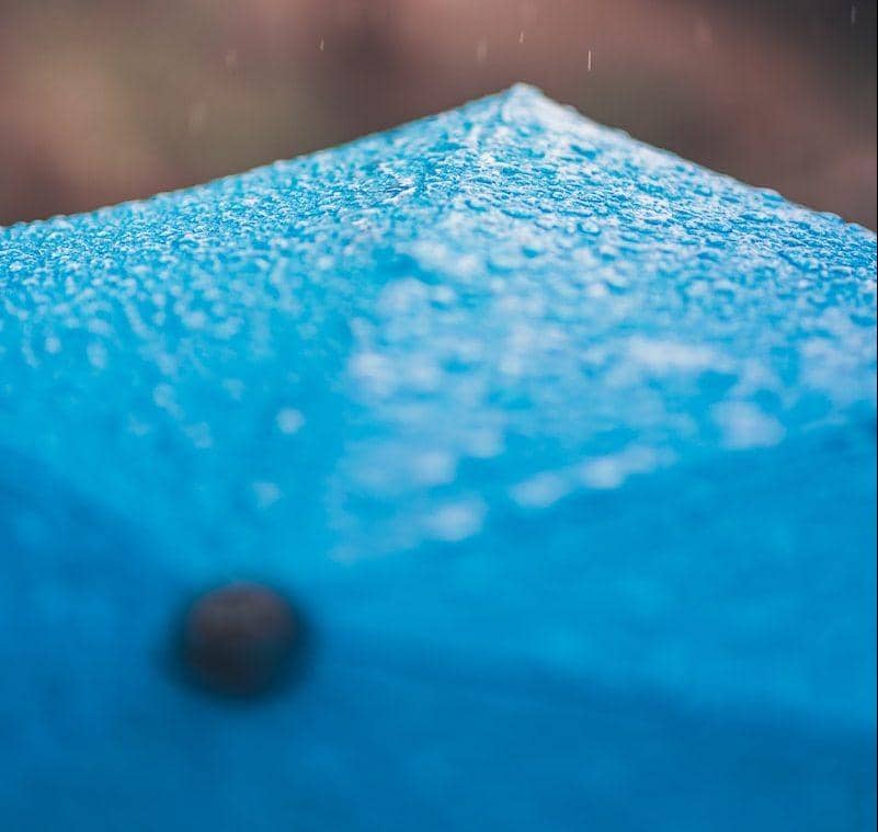 shallow focus photography of blue umbrella